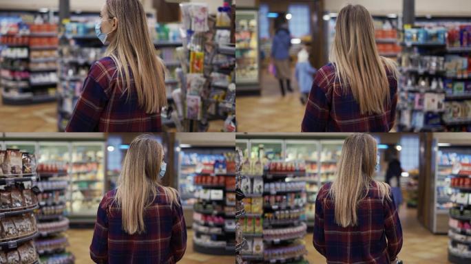 一名年轻女子在超市里推着一辆装满食品的车