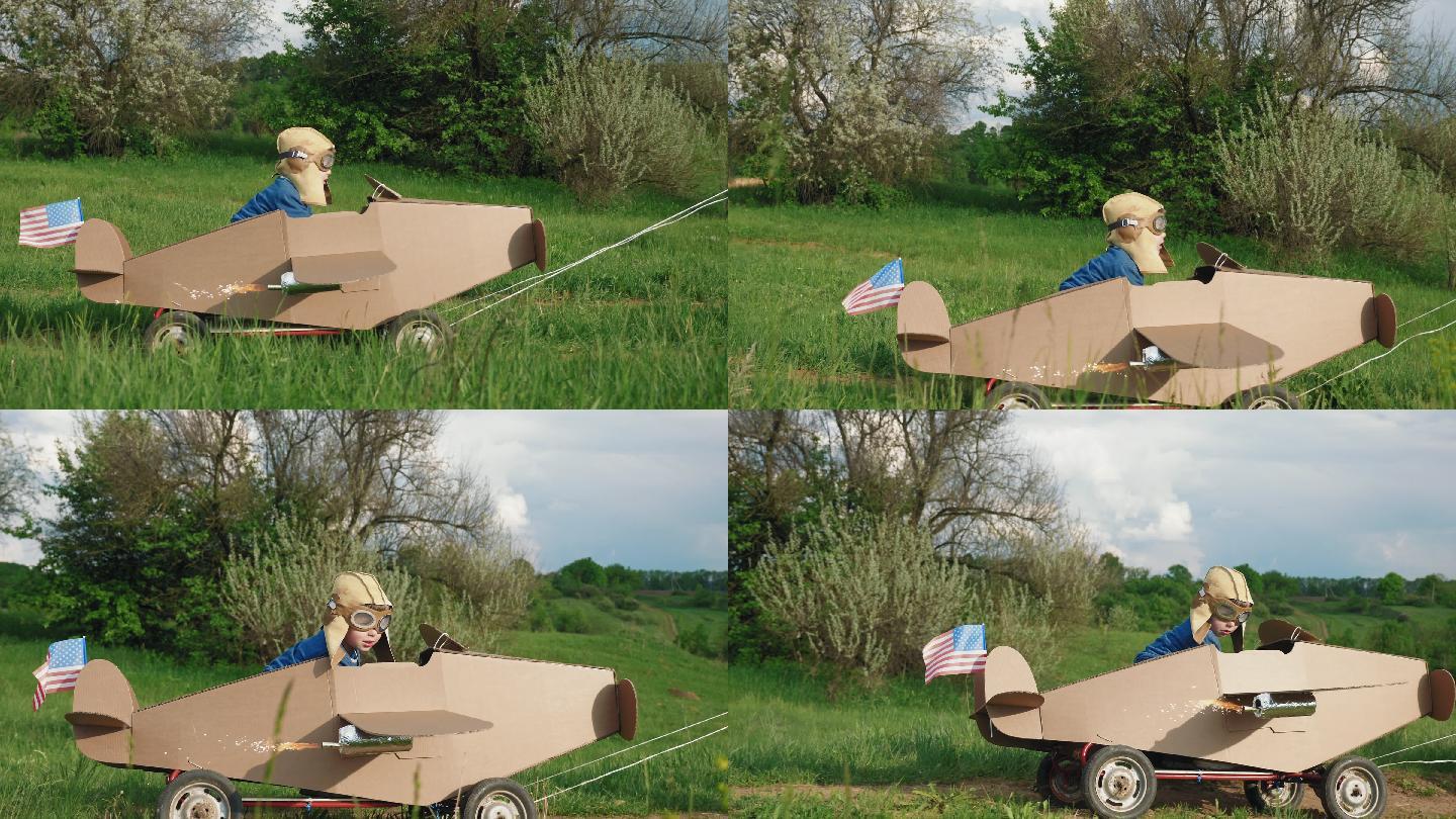 一个小男孩骑着自制的纸板飞机