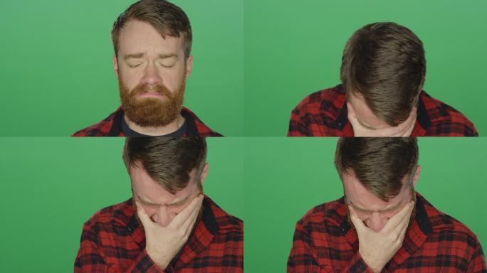 一个留着胡子的年轻人看起来很悲伤