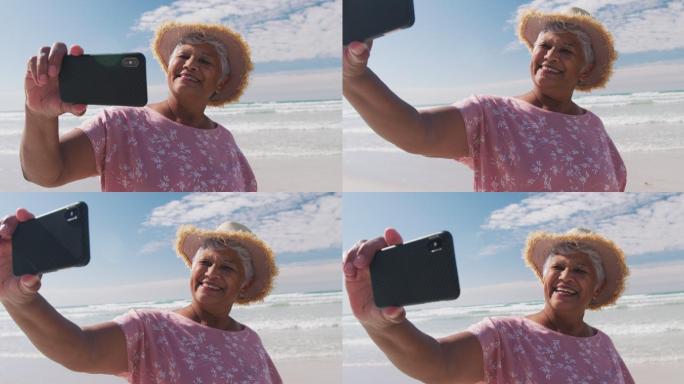 老年女性在海滩用智能手机自拍