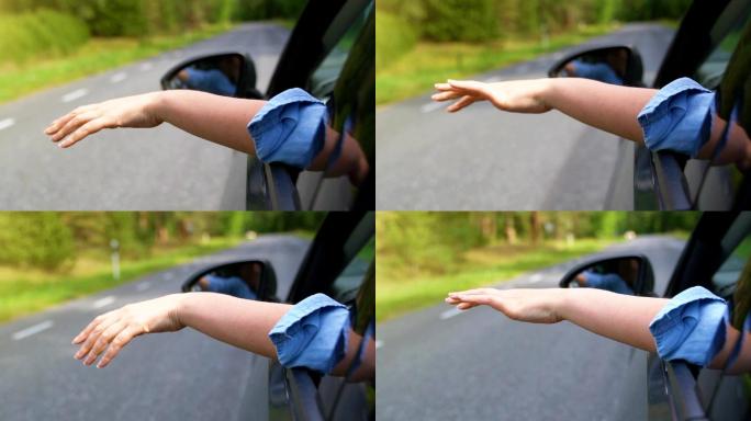 女人的手伸出车窗。