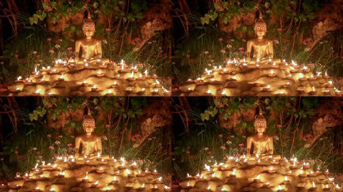 泰国清迈菩提树下点燃蜡烛的佛像