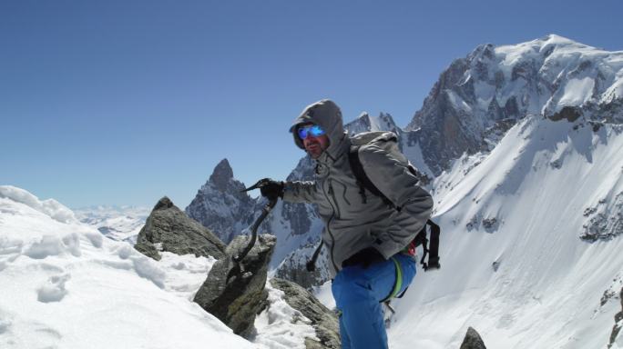 登山者用冰斧到达雪山顶。