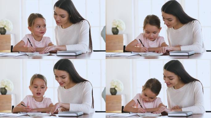 妈妈帮助女儿做家庭作业