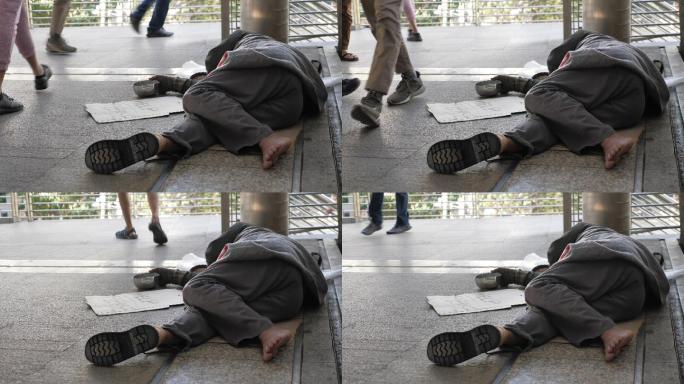 无家可归的老人穿着脏衣服睡在街上