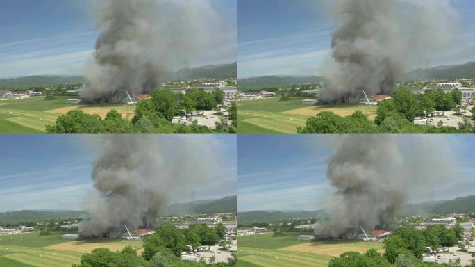 空中：消防员试图扑灭农村正在燃烧的工厂的大火