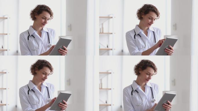 微笑的女医生在医院使用数字平板电脑