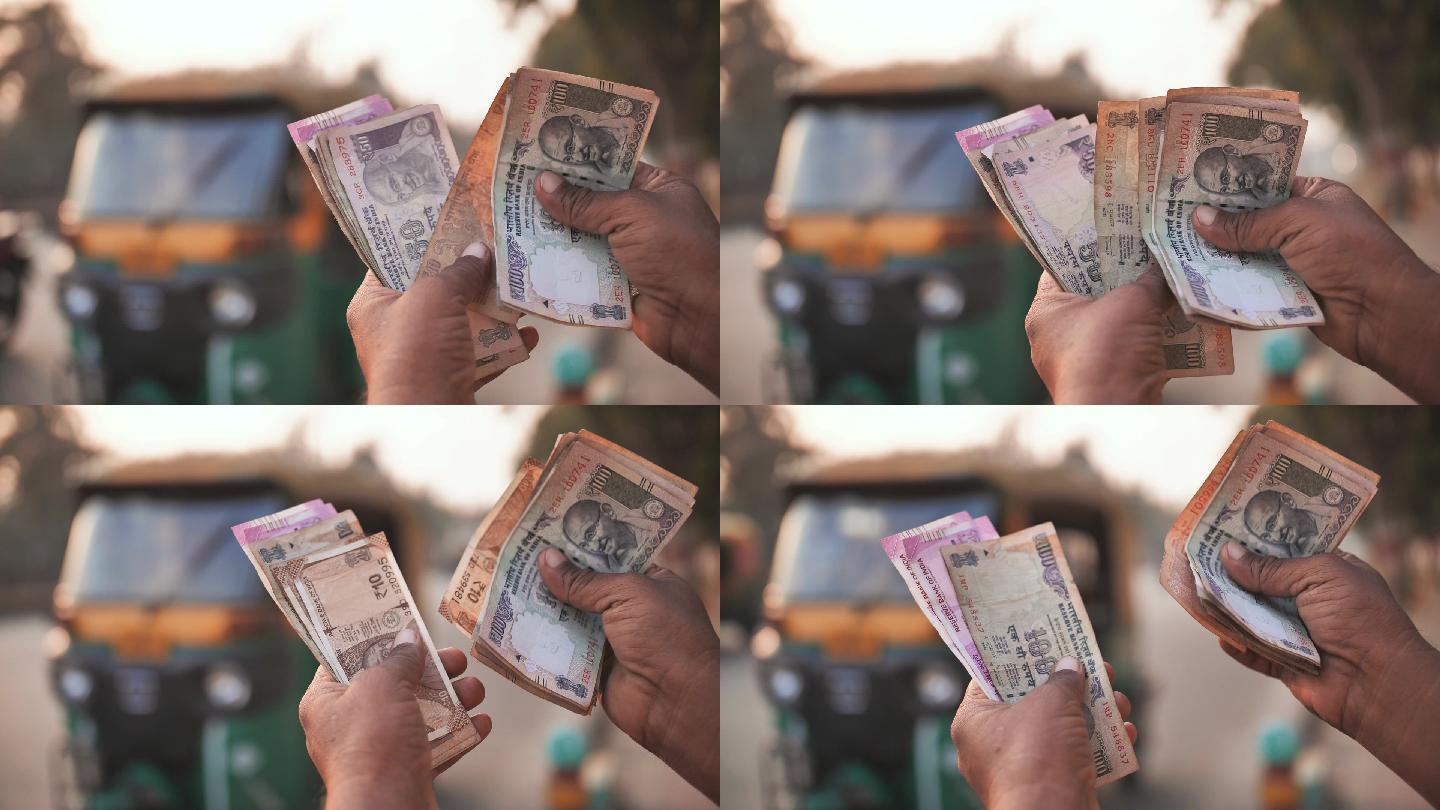一名男子在数钱印度卢比现金纸钱钞票纸钞