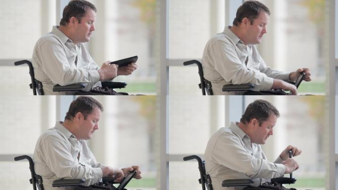 轮椅上的男人艰难的使用手机
