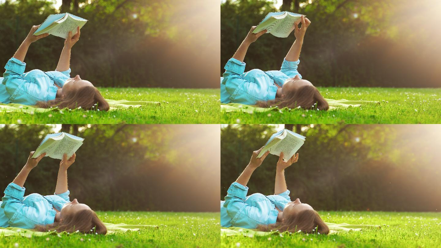 女人躺在草地上看书。