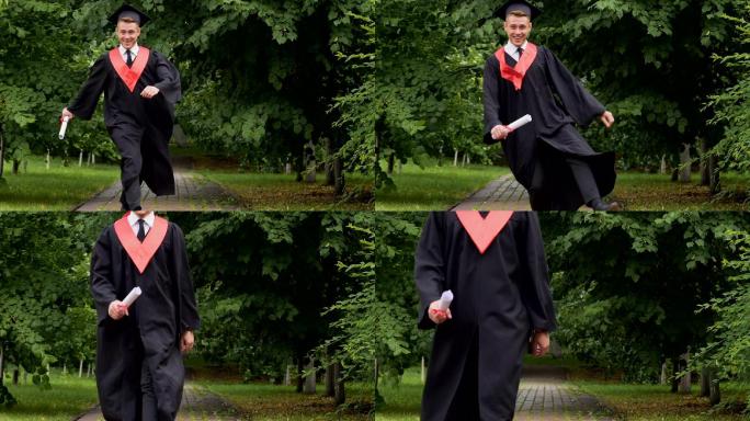 快乐微笑的毕业生拿着毕业证书在公园里散步