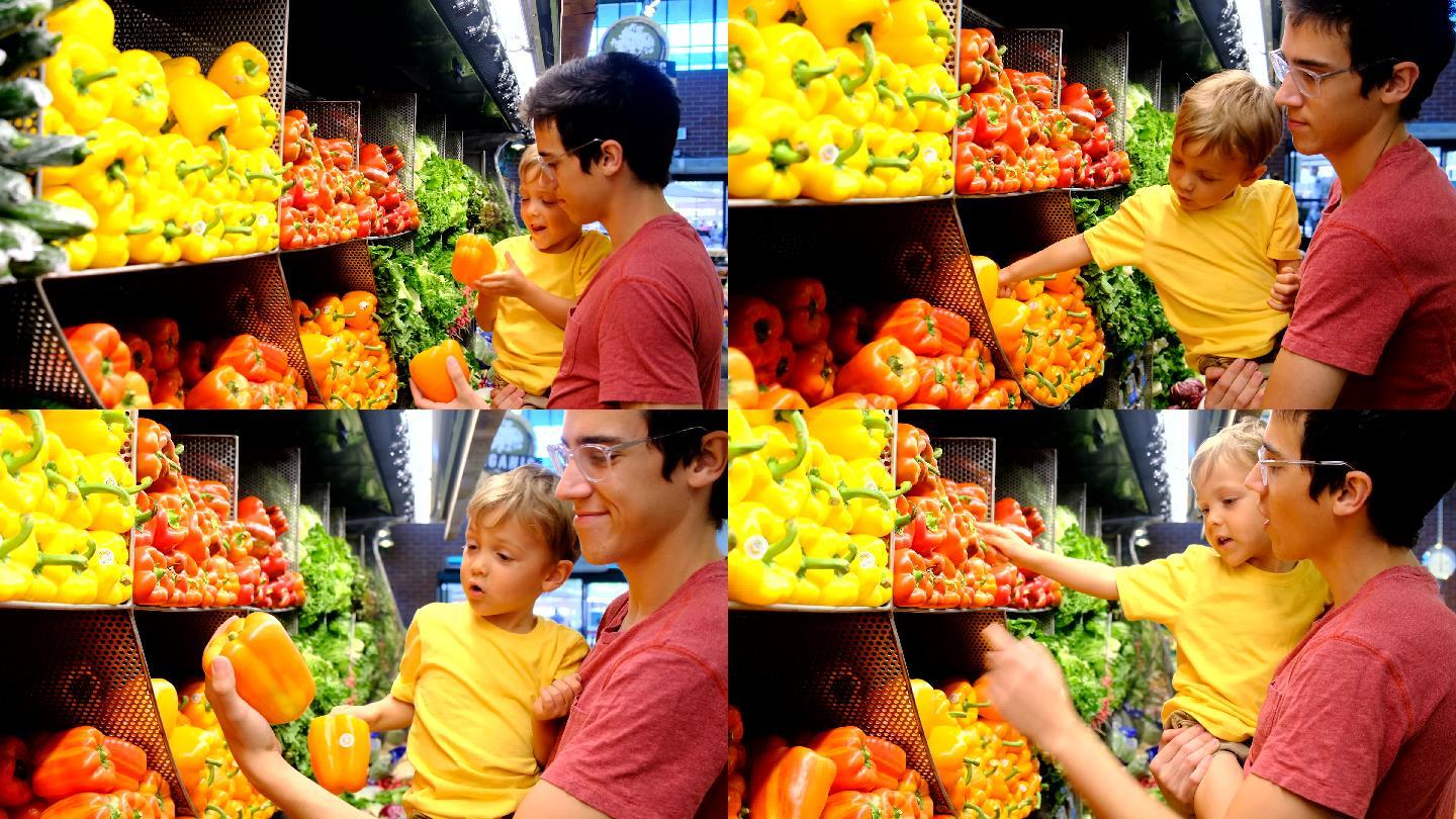一对年轻的父子在超市的蔬菜区买蔬菜