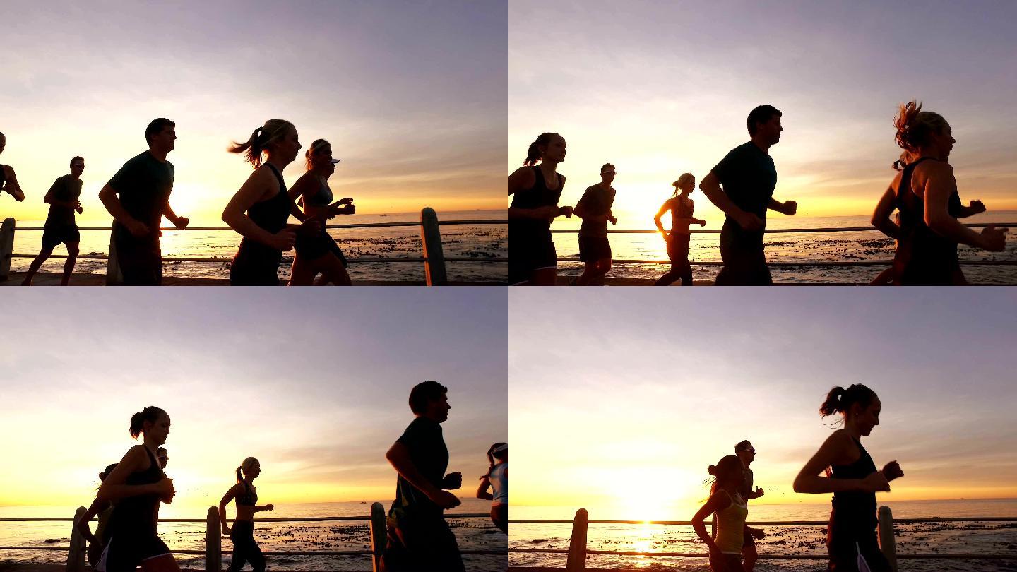 日落中的一群跑步者在锻炼