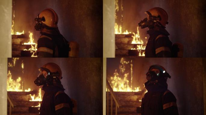 一位勇敢的消防队员视察燃烧着的建筑物