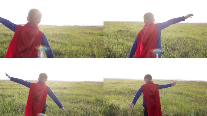 穿着超人斗篷的男孩在田野里奔跑