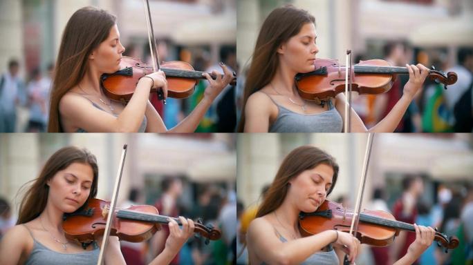 年轻的女子在步行街上拉小提琴