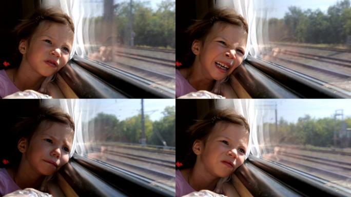 小女孩在火车上透过窗户看风景