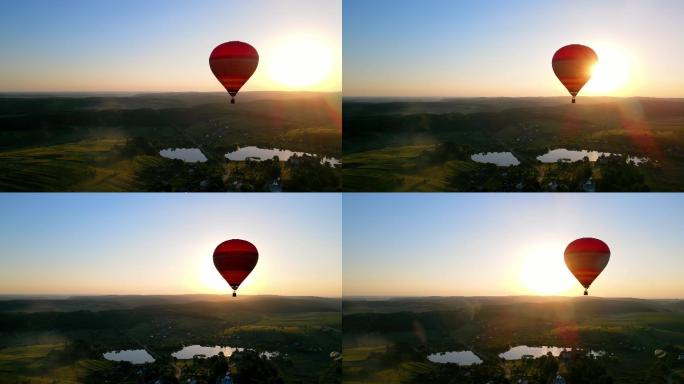 夕阳西下时，气球在地平线上飞行。