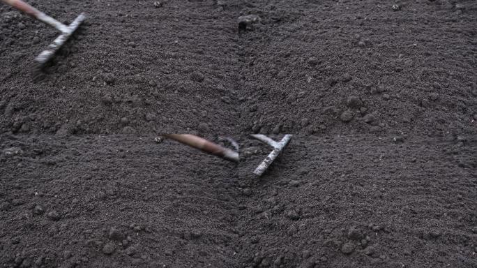 园丁使用花园土壤耙来分解土壤