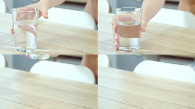 从厨房桌子上拿一杯水的特写镜头。