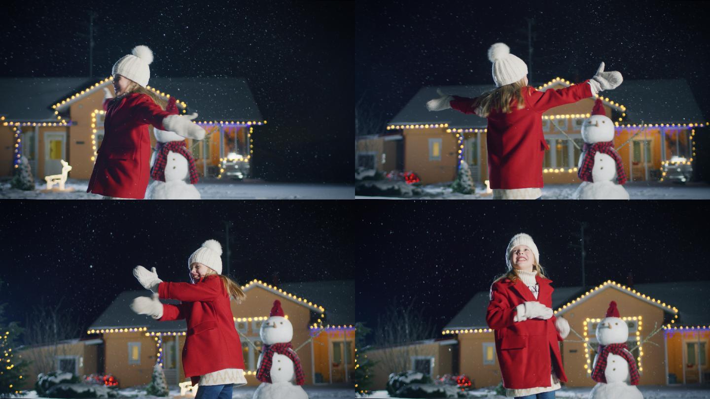 可爱的小女孩跳舞玩雪堆雪人新年