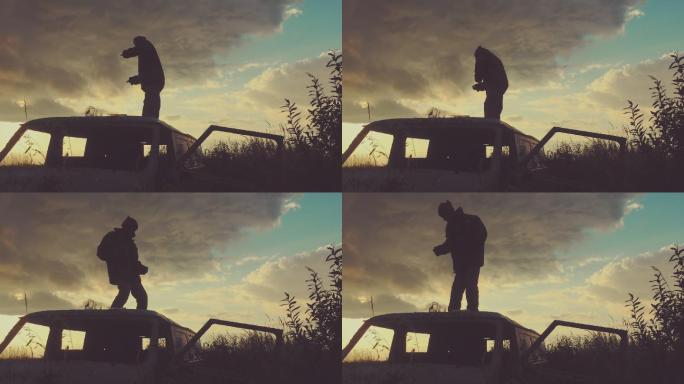 这名男子在废弃汽车车顶上跳舞