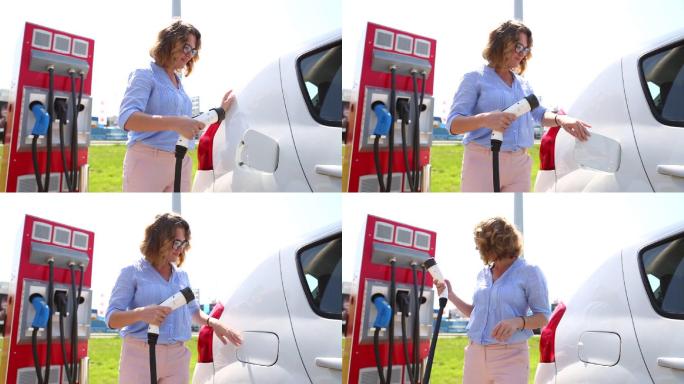 一名女子在电动汽车充电站工作
