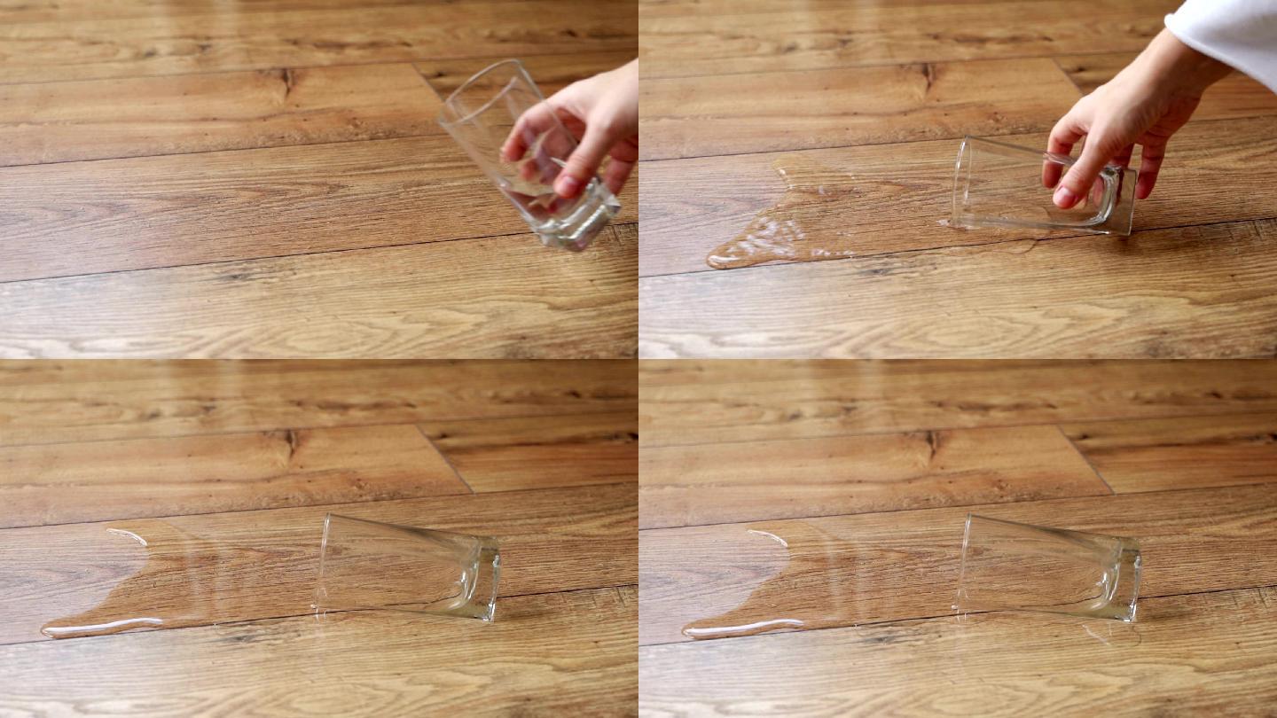 一杯水洒在木地板上