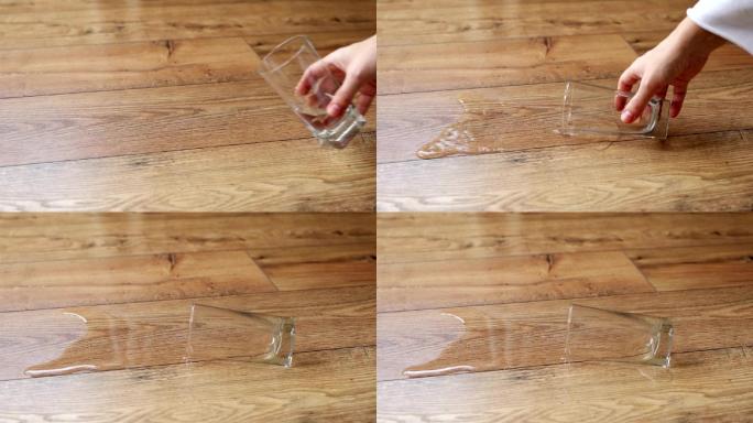 一杯水洒在木地板上