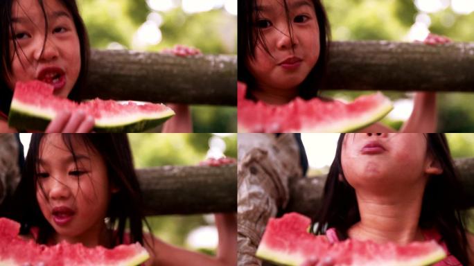 在公园里吃西瓜的小女孩
