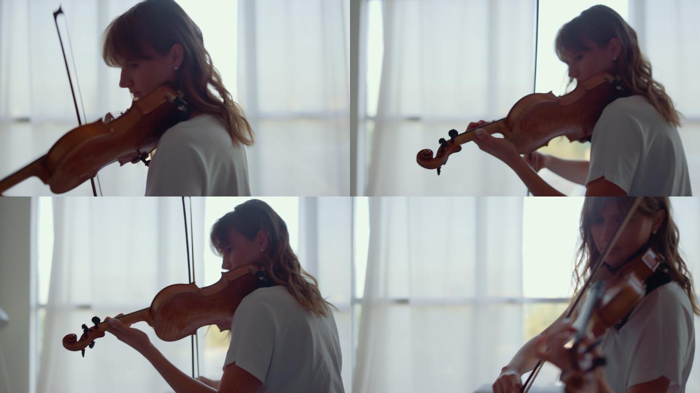 用弓拉小提琴练习音乐的女孩。