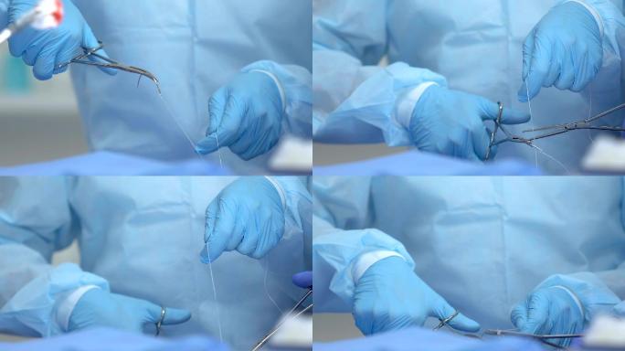 医生和护士用无菌外科针头缝合