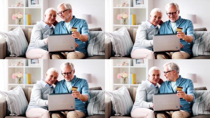 拥有笔记本电脑和信用卡的快乐老年夫妇