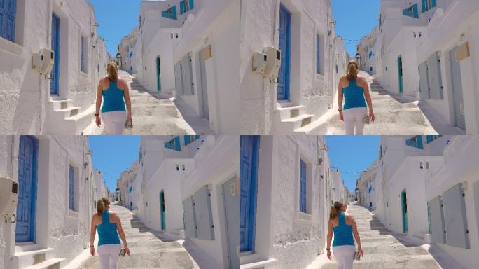 女游客慢镜头探索古希腊传统街道的后视图