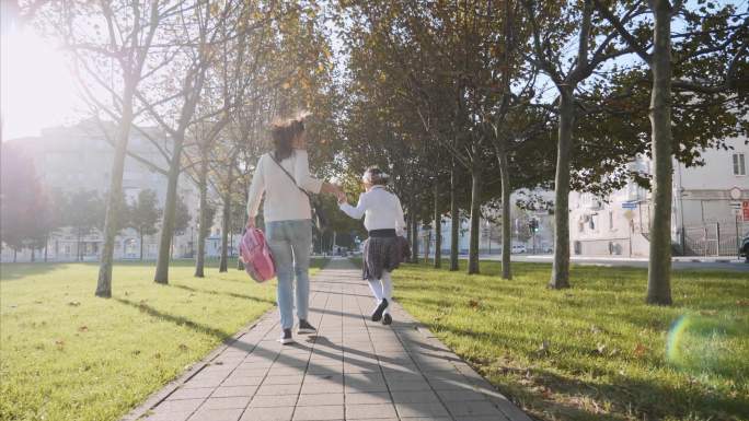 女人和小女孩在公园里奔跑，上学迟到