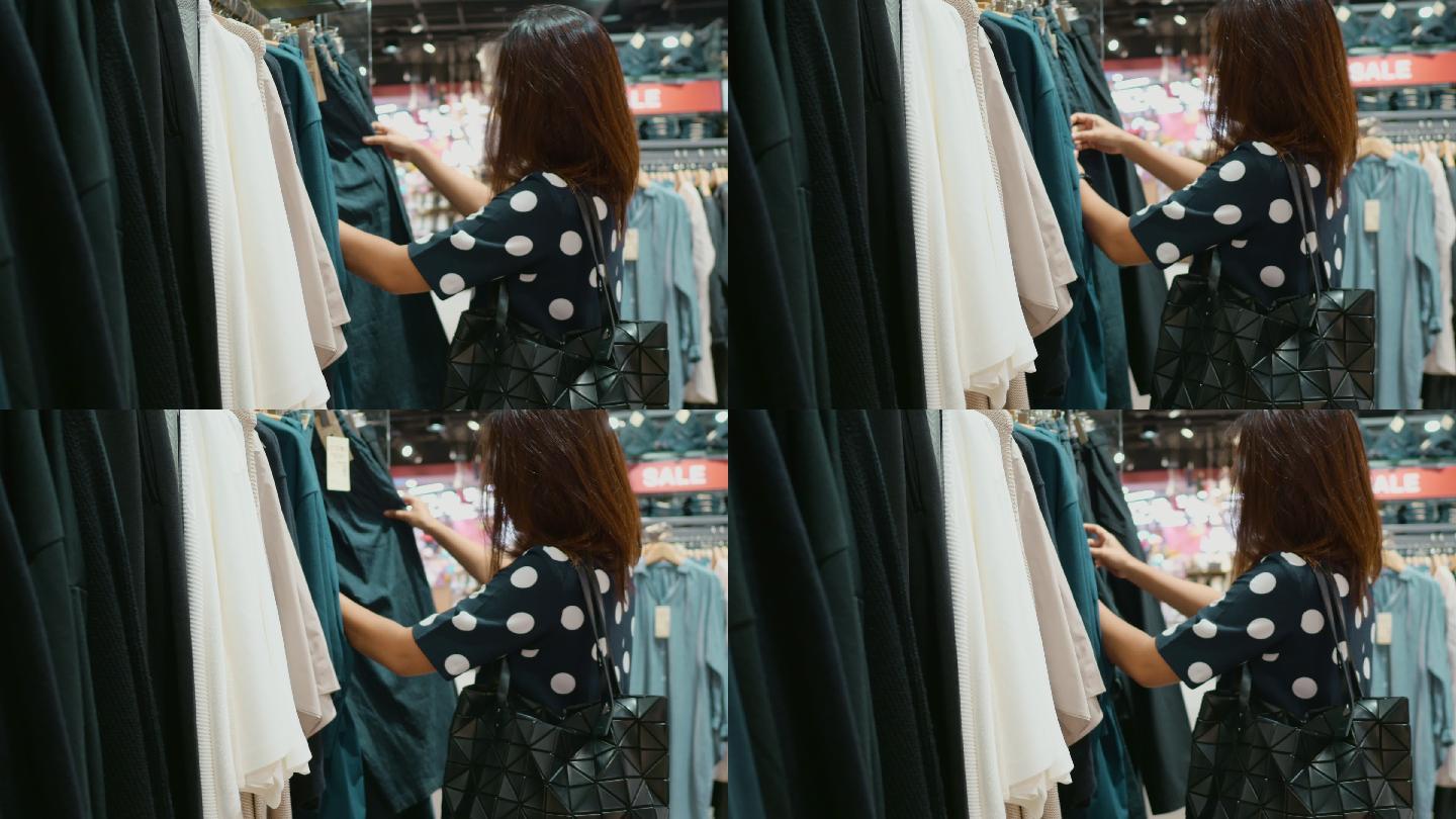 女人在商场购物时尚搭配购物袋购买衣服