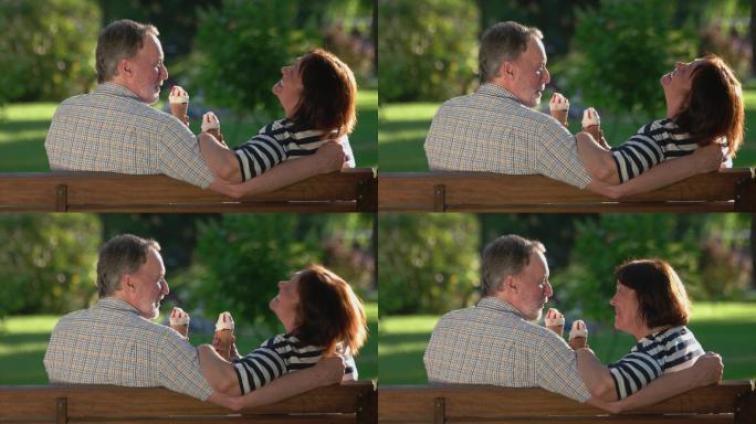 快乐的夫妇在户外吃冰淇淋。