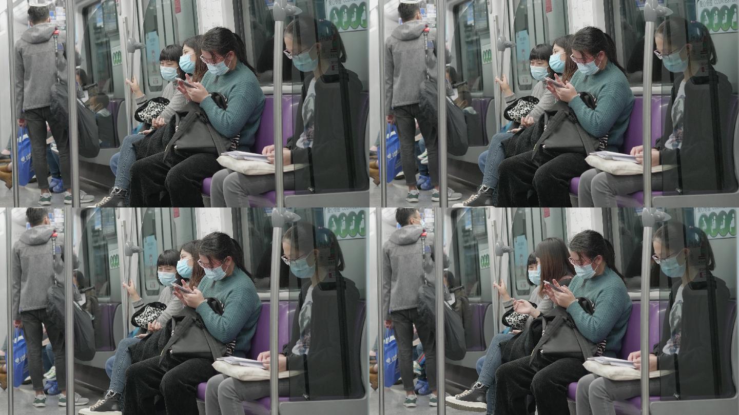 戴口罩乘地铁看手机