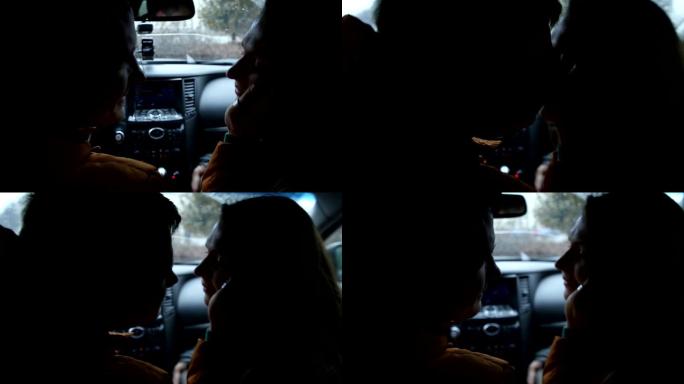 恋爱中的男人和女人坐在车里深情地看着对方