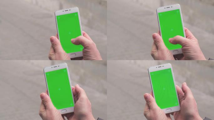 女性双手使用绿色屏幕手机