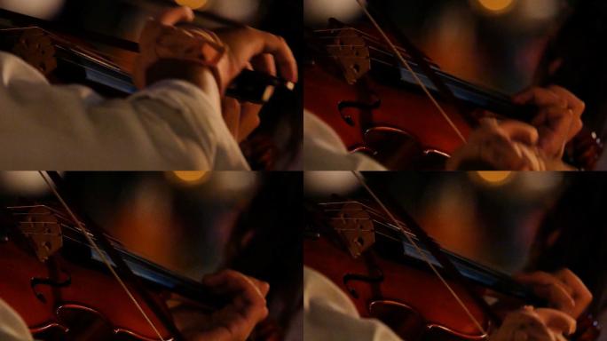 音乐家在户外夜间音乐会上拉小提琴