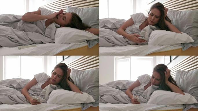 不高兴的女人在床上醒来并使用手机