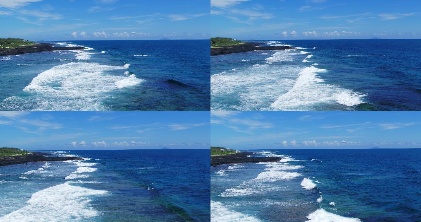 白色滚滚海浪拍打礁石滩的航拍素材