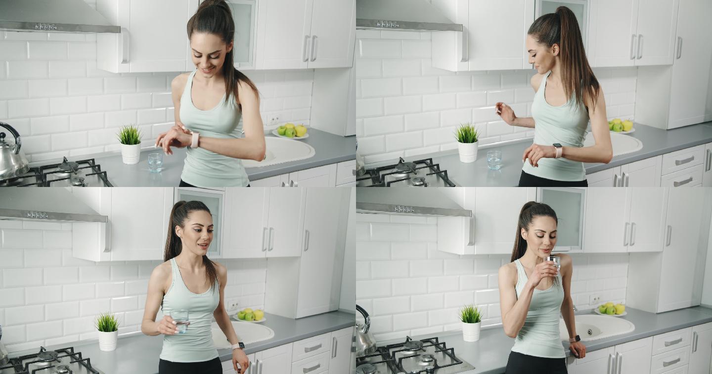 女性锻炼后在厨房喝水
