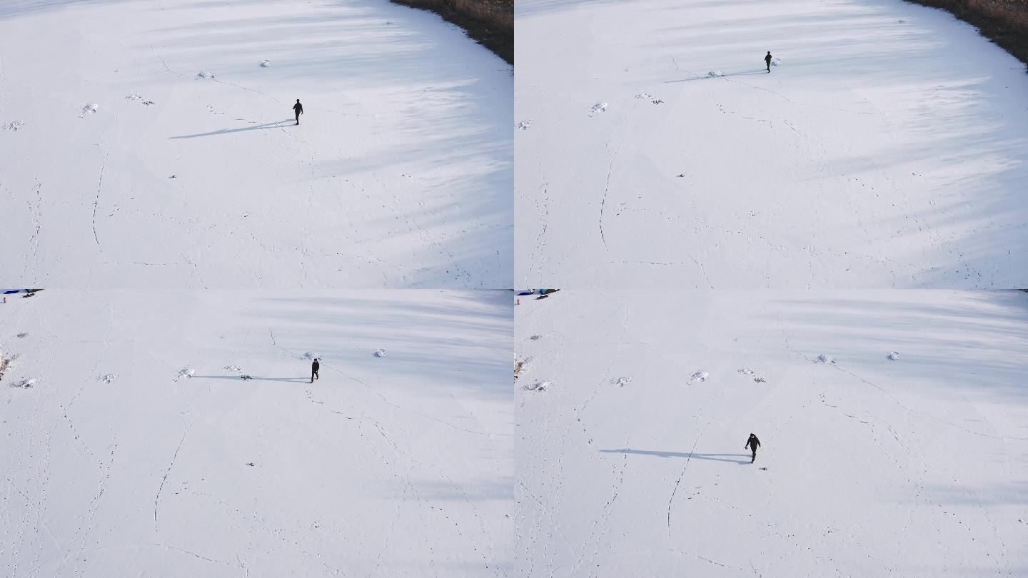 航拍一个人在雪地中孤单的行走