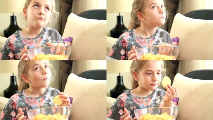 快乐的小女孩在吃薯片