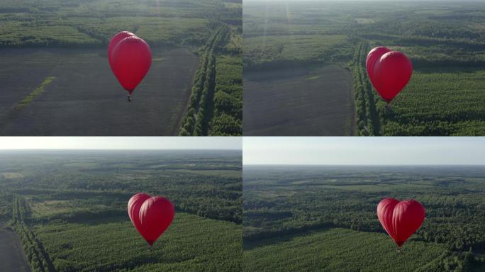 红色的爱气球在天空中飞过绿色的田野