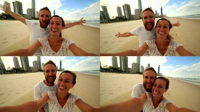 年轻夫妇在冲浪天堂海滩自拍