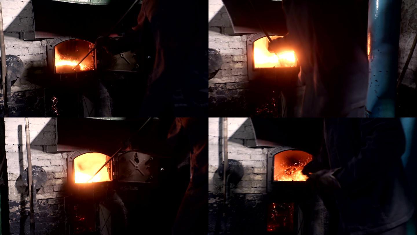人在炉子里点火生产设备自动化工厂制造