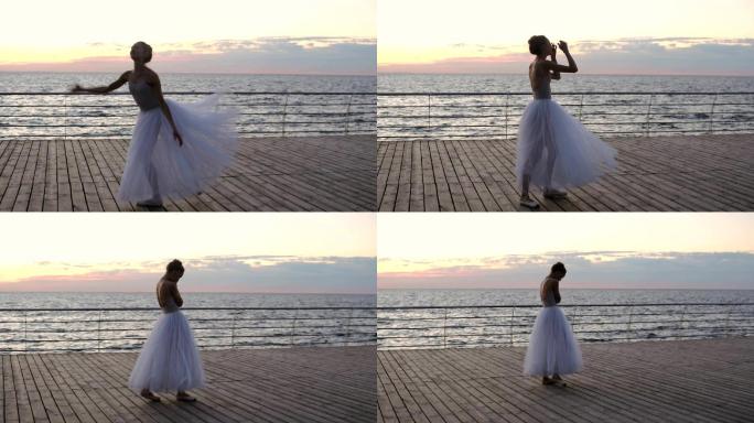 日落时在海堤上锻炼的芭蕾舞演员。